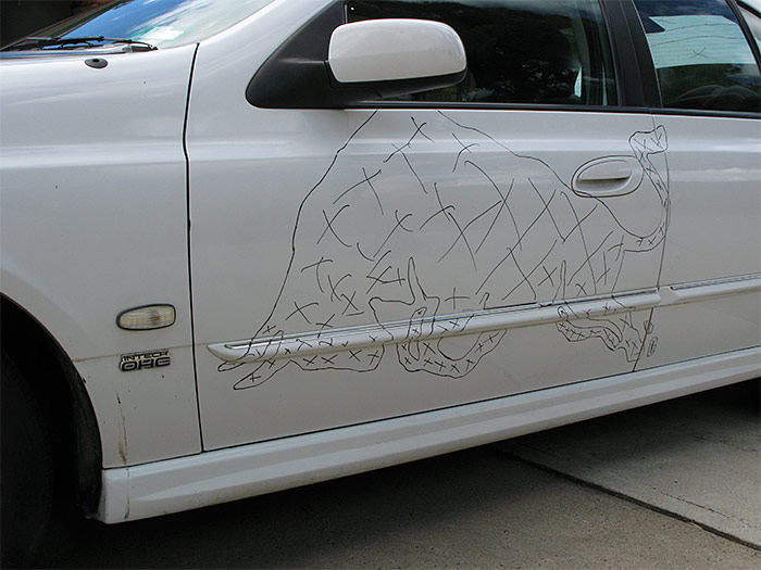The bull drawn on the doors in black marker